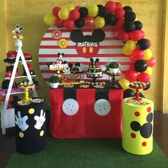 a mickey mouse themed birthday party with balloons