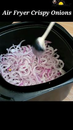 an air fryer crispy onions is being cooked in the crock pot with a spatula