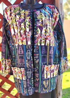 a mannequin's torso wearing a multicolored jacket with patches on it