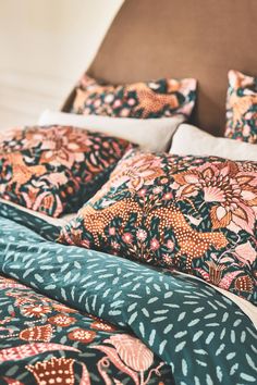 the comforter is made up and has many different patterns on it, including flowers