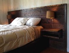 a bed with a wooden headboard and night stand