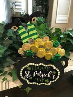 a st patrick's day pot full of gold coins and shamrocks with a sign that says happy st patrick's day