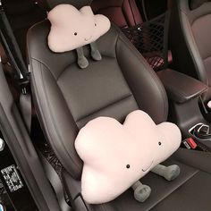 the interior of a car with two stuffed animals on it