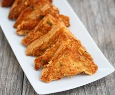 several pieces of fried food on a white plate