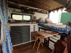 the interior of a camper with lots of storage space and wood flooring is shown