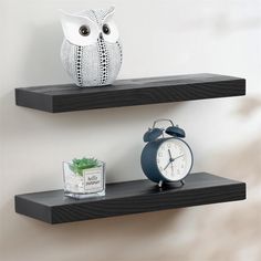 two black shelves with an alarm clock and owl figurine