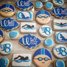 decorated cookies with blue and white frosting are arranged on a table