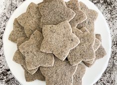 a white plate topped with crackers on top of a counter