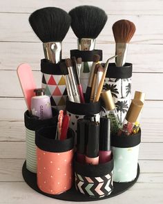 an organized makeup brush holder on a white wooden background