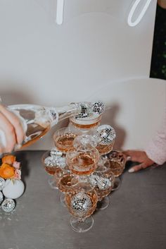 Neutral picnic scene on wooden picnic table with backdrop of baloon arch and disco balls. Pink and gold bud vases with ranunculus, baby's breath, dahlias, and roses. Champagne tower with rosé and macarons. Mini Disco Ball Decor, Mini Disco Ball, Disco Ball Decor, Bachelorette Inspo, Dance And Music