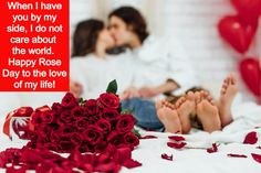 two people laying in bed with red roses on the floor and one person kissing her