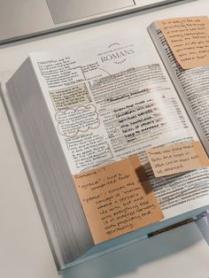 an open book with sticky notes attached to it