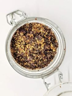 a glass jar filled with granola sitting on top of a table