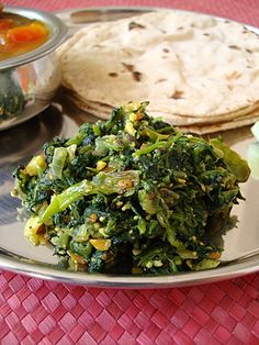 a plate with some vegetables and pita bread on it