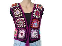 Crochet vest for women with natural colors. Premium quality Crochet square motifs handmade granny vest from microfiber acrylic. I made all the motifs in colour, but the surrounding is wine-coloured. Please review the photos. Everything in my store was made by me with care. Other Vests: https://www.etsy.com/shop/MimosaKnitting?ref=seller-platform-mcnav&section_id=37507105 SIZE: Fits S/M size. Please follow the care instructions to preserve the appearance and prolong the life of the garment. MAINT Handmade Bohemian Vest For Festival, Bohemian Sleeveless Winter Tops, Fitted Multicolor Bohemian Vest, Handmade Bohemian Festival Vest, Multicolor Sleeveless Hippie Vest, Folk Style Multicolor Festival Vest, Handmade Casual Vest, Handmade Multicolor Vest For Festival, Handmade Multicolor Festival Vest