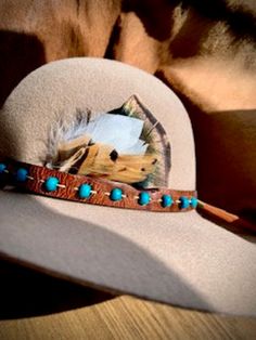 A custom made hat band feather accessory for men or women. This custom hat feather is made with a goose down, pheasant, and a Turkey Feather. This feather can also be made into a hair accessory or a wedding boutonniere. Depicted with a hat and band for reference, item does not include hat or leather band. Southwestern Feather Hat Band For Country Events, Bohemian Hat Bands With Feathers For Ranch, Southwestern Hat Bands With Feathers For Ranch, Bohemian Style Hat Band With Feathers For Country Events, Bohemian Hat Bands With Feathers For Country Events, Felt Hat With Feathers For Kentucky Derby Festival, Felt Hat With Feathers For Kentucky Derby, Bohemian Hat Band With Feathers For Ranch, Bohemian Style Feathered Hat Bands For Country Events