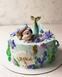 there is a birthday cake with a little mermaid on it