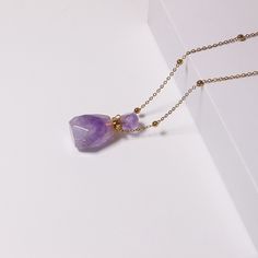 PLEASE NOTE: Our crystal stones are natural minerals and each crystal is unique. The internal ice cracks, pits, mineral points, and color differences of natural crystals are all formed naturally and are normal phenomena, which will not affect the efficacy, beauty and value of the crystal at all.Delight your senses every day with a natural aromatherapy amethyst pendant. Simply unscrew the top and place in your favourite essential oil or perfume. You can add drops of essential oils into the bottle Amethyst Raw Stone Necklace For Healing, Spiritual Amethyst Crystal Necklace With Raw Stone, Healing Natural Stone Crystal Necklaces, Healing Mineral Crystal Necklace With Natural Stones, Healing Mineral Crystal Gemstone Necklace, Quartz Crystal Necklace With Raw Stone For Healing, Amethyst Raw Stone Crystals For Gift, Amethyst Gemstone Crystal Necklace For Gift, Healing Lavender Necklace With Natural Stones