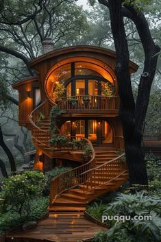 a tree house in the woods with stairs leading up to it's second story