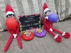 two elfs are sitting on a couch with balloons and a chalkboard that says love life & chips