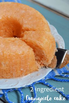 two ingredient orange cake on a white plate with a blue and white napkin next to it