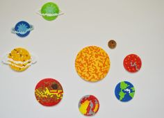 there are six different designs made out of bead balls on the table, and one is in the shape of a planet