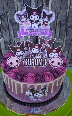 a birthday cake decorated with purple icing and skulls