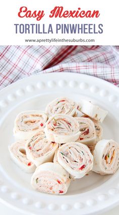 a white plate topped with tortilla pinwheels