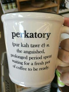 a person holding a coffee cup with the words perkatory on it