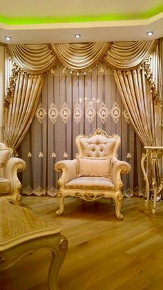 an elegant living room with gold furniture and curtains