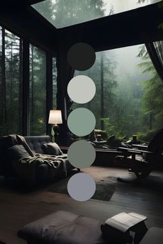 a living room filled with lots of furniture next to a forest covered in foggy trees