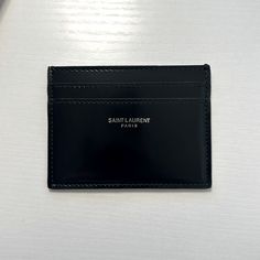 a black card case sitting on top of a white table