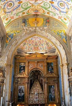 the interior of an ornate church with paintings on the walls and ceiling, painted in bright colors