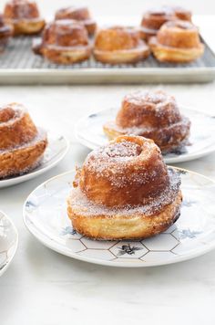 several pastries are sitting on white plates