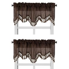 two brown curtains with tassels hanging on the top and bottom of each curtain