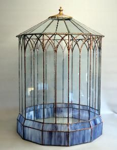 a blue birdcage sitting on top of a white table