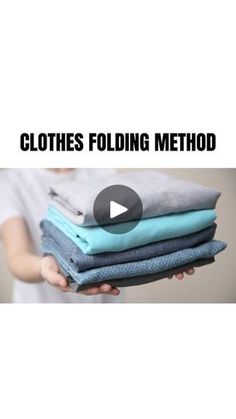 a person holding several folded clothes with the words clothes folding method in front of them