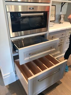 an open drawer in the middle of a kitchen