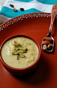 a bowl of soup with nuts on the side