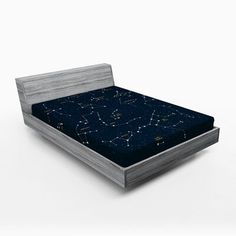 an image of a bed with blue sheets and stars in the night sky on it