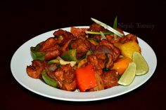 a white plate topped with meat and vegetables