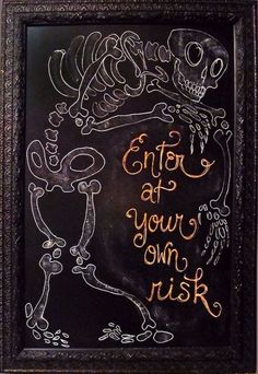 a chalkboard with writing on it that says, enter at your own risk and an image of a skeleton