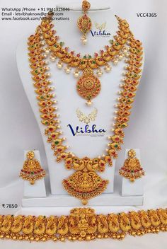 an elaborate necklace and earrings set in gold