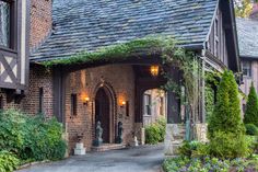 an old brick building with ivy growing on it's roof and door way leading to the entrance