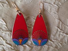 "Laurel Burch Earrings KIRIN PEACOCK Dangle French Ear Wires Red Teal Gold Vintage Jewelry 1980s These gorgeous Laurel Burch teardrop earrings are done in a bright red with accents of teal over shimmering polished brass; cool vintage finds from the 1980s. Each measure approx. 1.25\" X 3/4\" with 14k Gold Filled French Ear Wires with gold beads & coils. Named and signed on the back: KIRIN/Laurel Burch.  A Genuine LAUREL BURCH COLLECTIBLE from the mid-1980s. This hard to find pair is in lovely con Vintage Red Teardrop Jewelry, Retro Multicolor Metal Earrings, Vintage Red Pierced Earrings, Retro Red Dangle Earrings, Red Enamel Pierced Earrings, Red Pierced Enamel Earrings, Red Enamel Drop Earrings, Red Enamel Earrings, Red Enamel Dangle Earrings