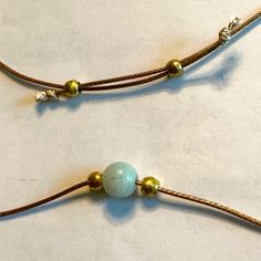 Light Green 8 Mm Amazonite Bead Brass Beads Are 4 Mm Golden Tan Waxed Nylon Cord Is 1 Mm Easily Adjustable Corded Beaded Necklace Has No Clasps And Simply Slips Over Your Head. Sliding The Brass Beads Away From Each Other Will Shorten The Necklace To Any Length That You Want. Gravity Does Eventually Lengthen The Necklace, But It Generally Takes A While. It’s Part Of The Wabi Sabi, The Perfectly Imperfect, Nature Of Hand Crafted Items In This @Pixielife Closet. Unique Jewelry Handmade By Pixie Li Adjustable Jade Jewelry For Meditation, Artisan Adjustable Beaded Necklace For Meditation, Handmade Adjustable Minimalist Beads, Adjustable Artisan Jade Jewelry, Adjustable Beaded Necklaces For Everyday, Adjustable Everyday Beaded Necklaces, Adjustable Artisan Beaded Necklaces, Adjustable Beaded Necklaces For Jewelry Making, Adjustable Brown Beaded Round Necklace