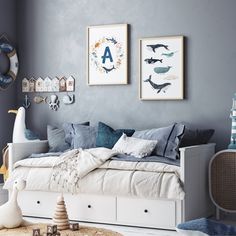 a bedroom with blue walls and white furniture, including a daybed in the foreground