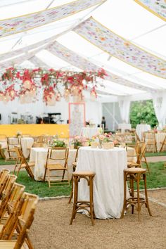 tables and chairs are set up under a tent