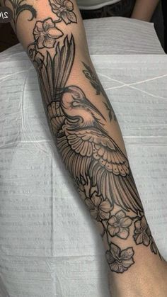 a person with a bird tattoo on their arm