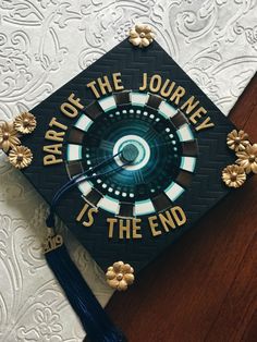 a graduation cap that says, part of the journey is the end